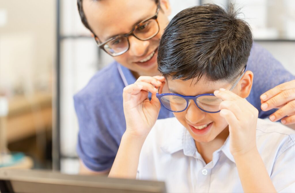 A father and son trying on glasses.