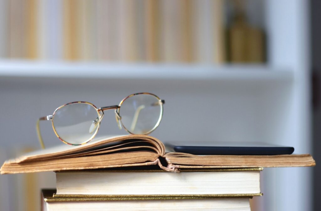 A pair of reading glasses resting on top of a book.