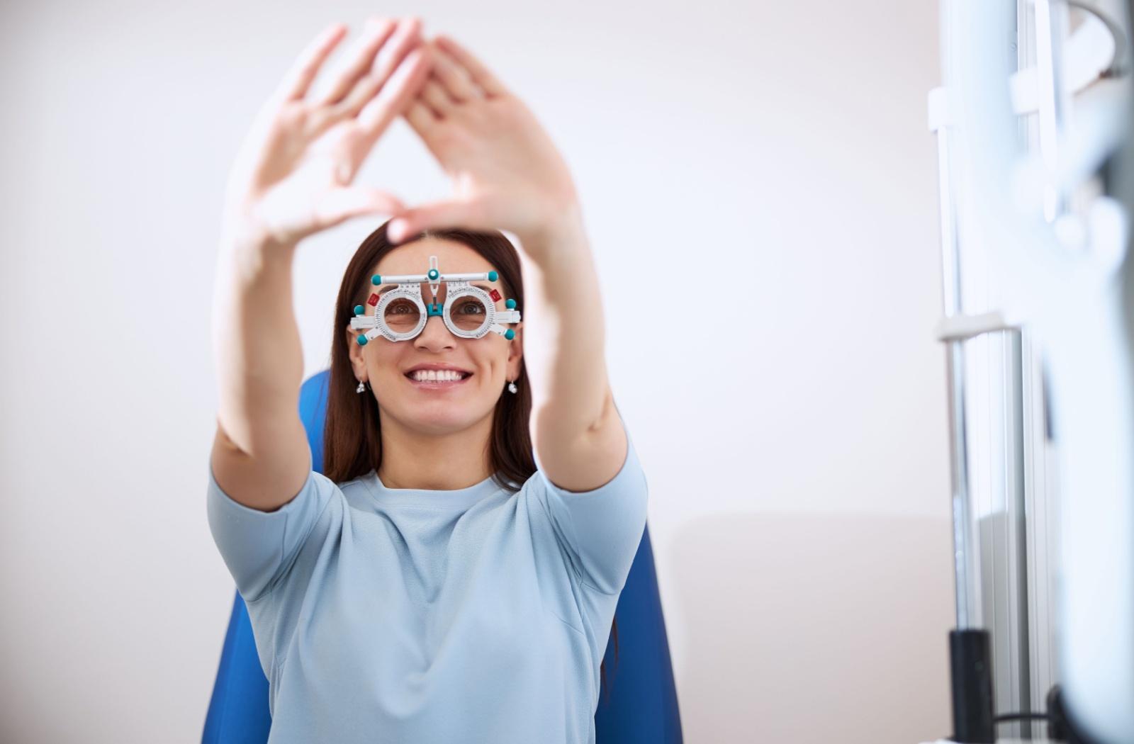 A patient at an optometry office holding their hands out in a triangle, testing which eye is dominant.